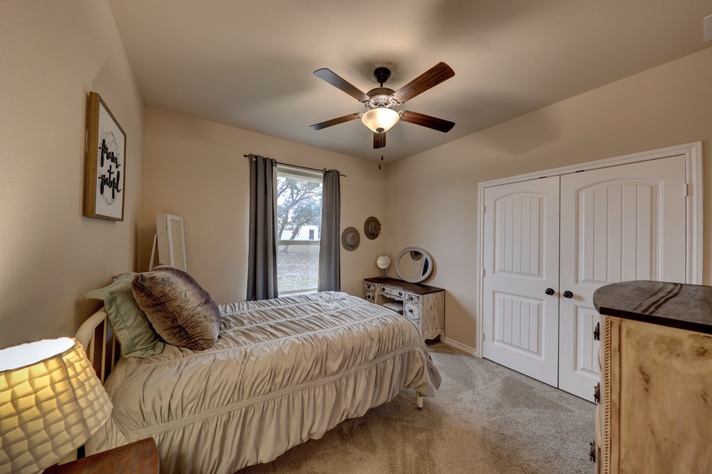 450 Jung Road Harper, TX 78631 - Photo 19 of 50 a bedroom with a bed and a window