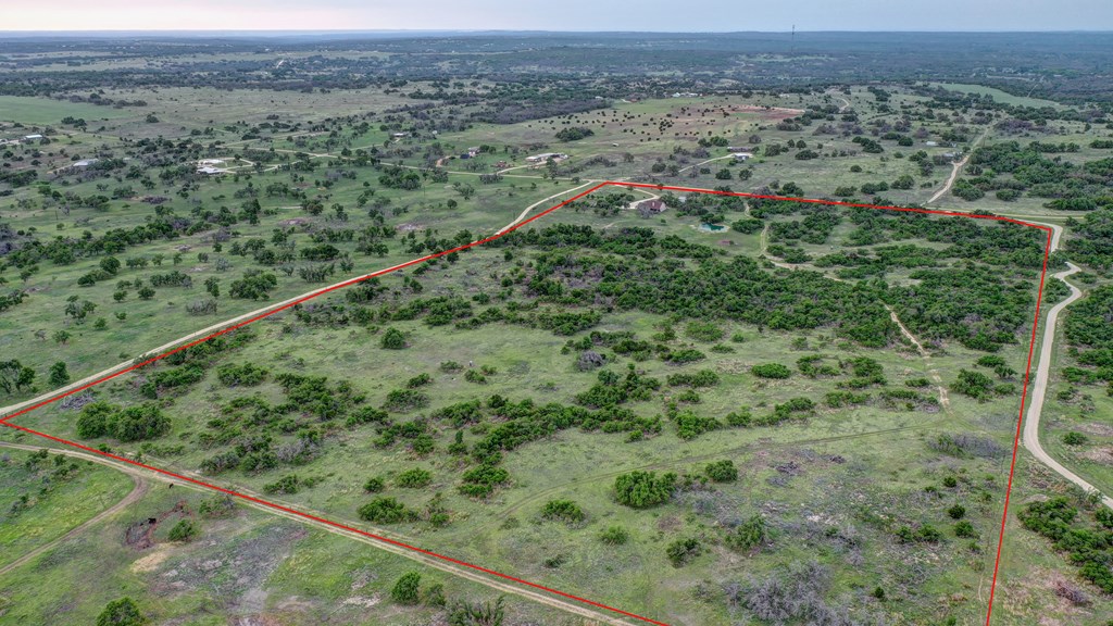 450 Jung Road Harper, TX 78631 - Photo 41 of 50 a view of a green field with lots of trees in the background