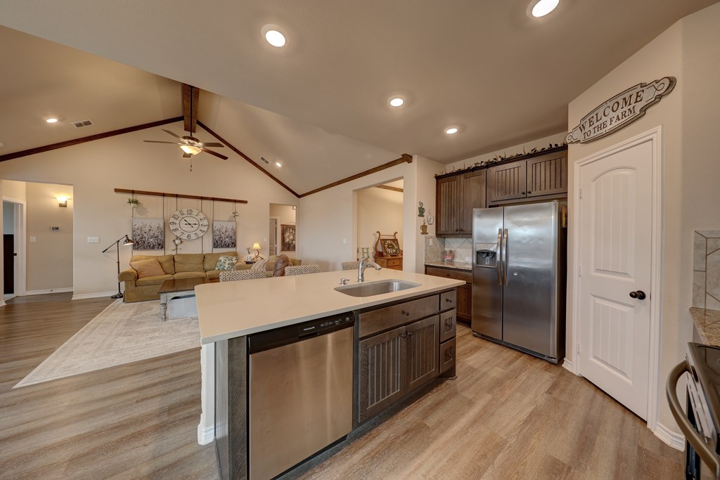 450 Jung Road Harper, TX 78631 - Photo 6 of 50 a kitchen with stainless steel appliances granite countertop a sink refrigerator and cabinets