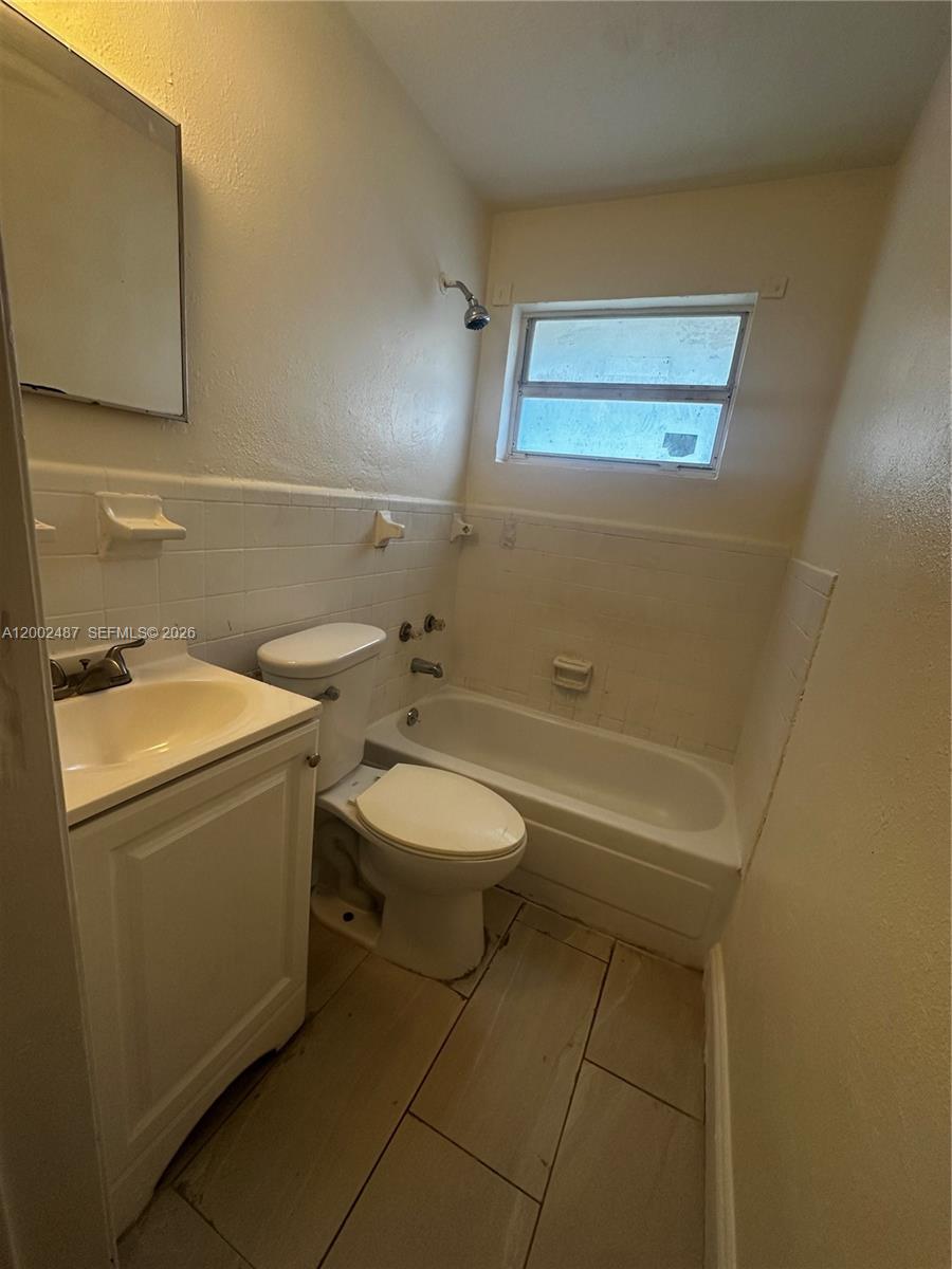 11862 Southwest 212th Street, Unit 11862 Miami, FL 33177 - Photo 11 of 24 a bathroom with a toilet sink and mirror