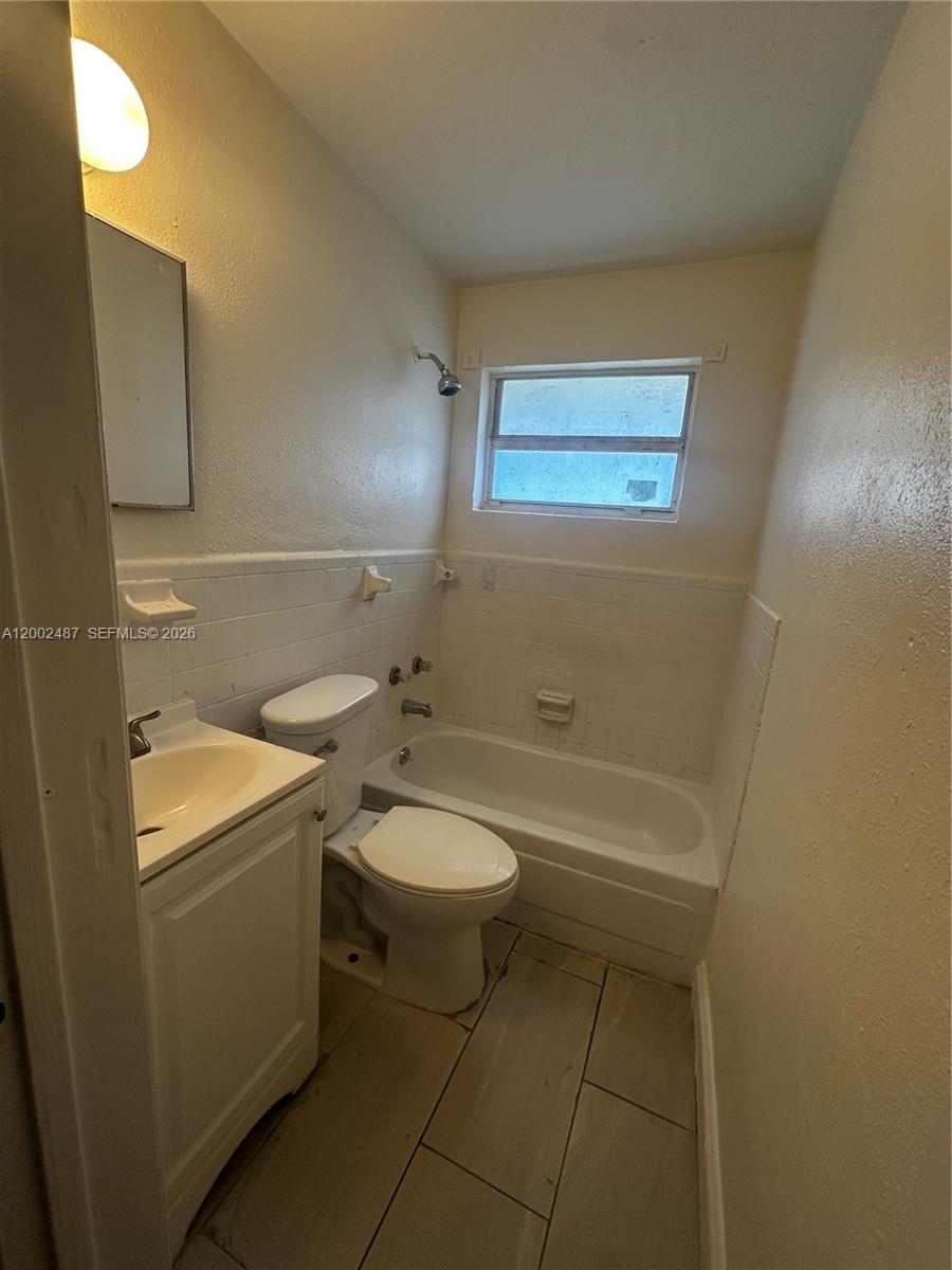 11862 Southwest 212th Street, Unit 11862 Miami, FL 33177 - Photo 12 of 24 a bathroom with a toilet a sink and bathtub