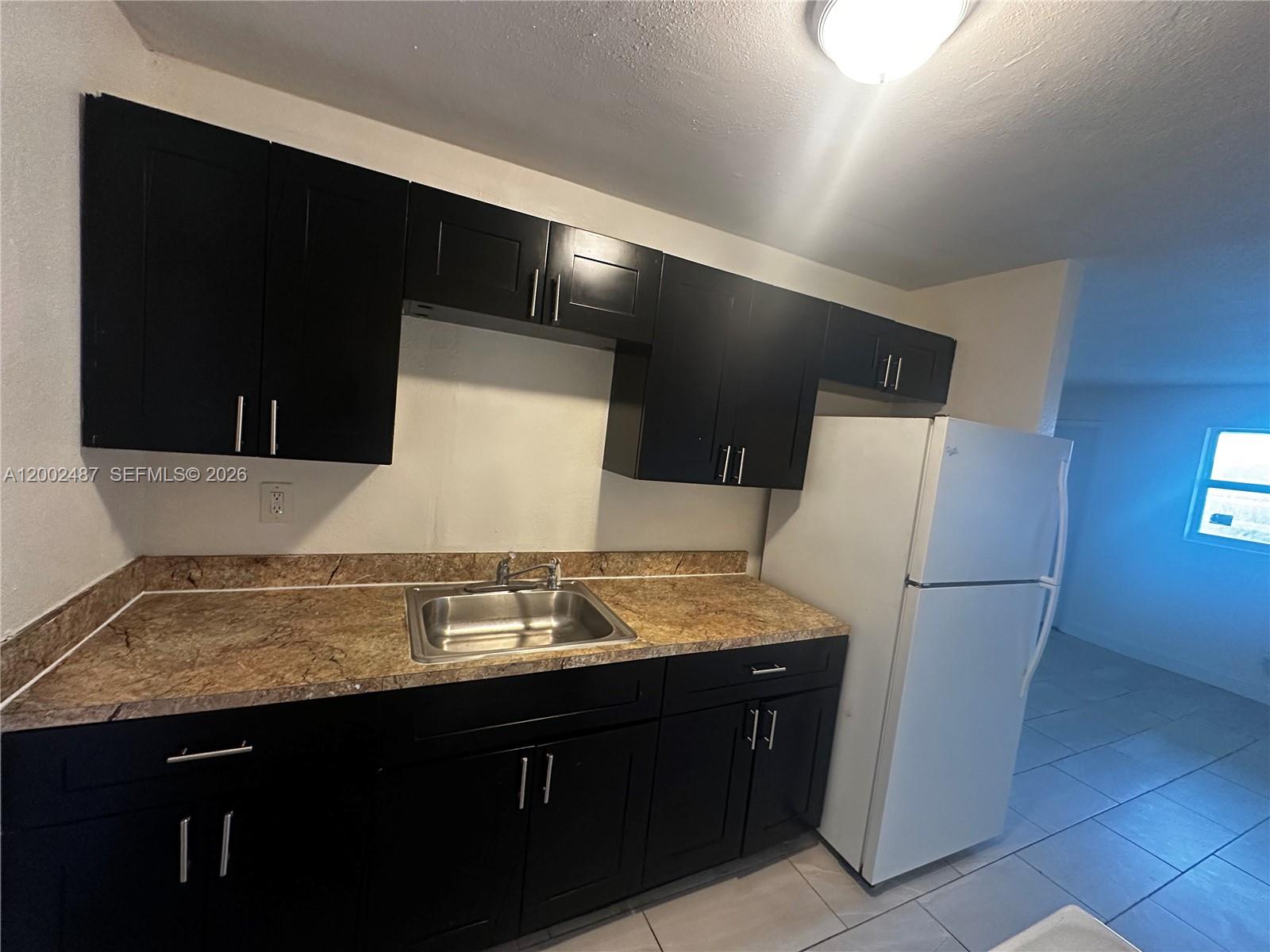11862 Southwest 212th Street, Unit 11862 Miami, FL 33177 - Photo 17 of 24 a bathroom with a granite countertop sink and a mirror