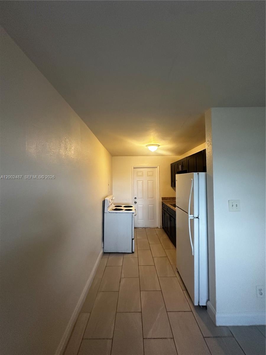 11862 Southwest 212th Street, Unit 11862 Miami, FL 33177 - Photo 18 of 24 a view of a refrigerator in kitchen and utility room
