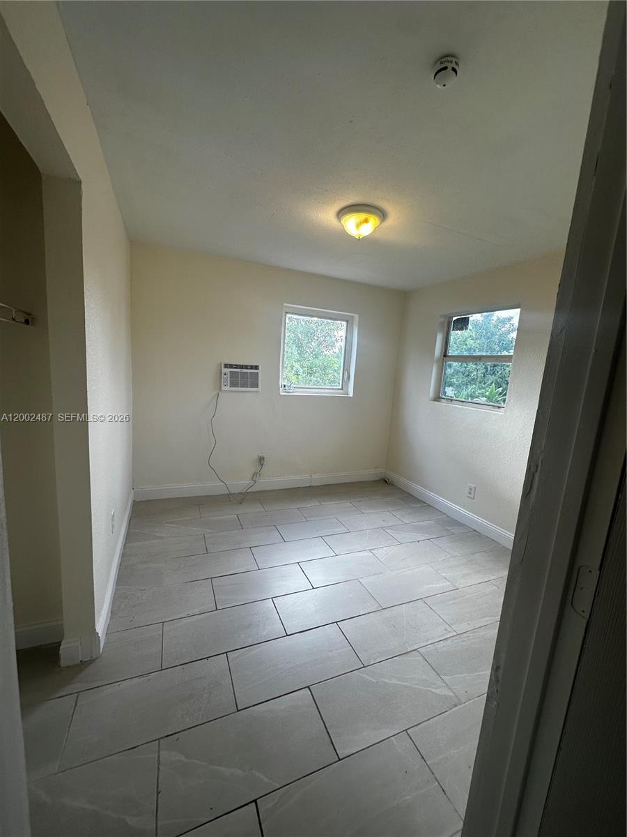11862 Southwest 212th Street, Unit 11862 Miami, FL 33177 - Photo 2 of 24 a view of an empty room with windows