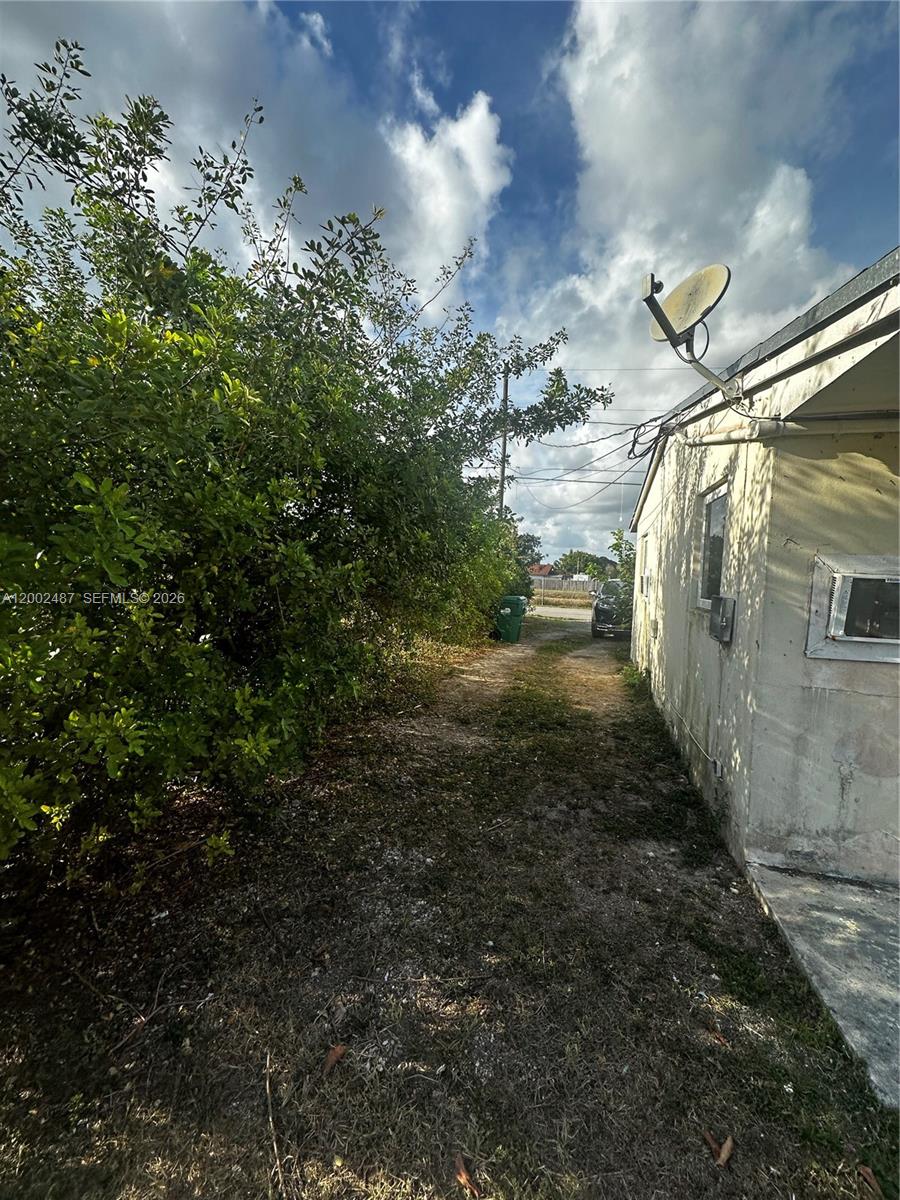 11862 Southwest 212th Street, Unit 11862 Miami, FL 33177 - Photo 22 of 24 a view of a pathway of a house with a yard