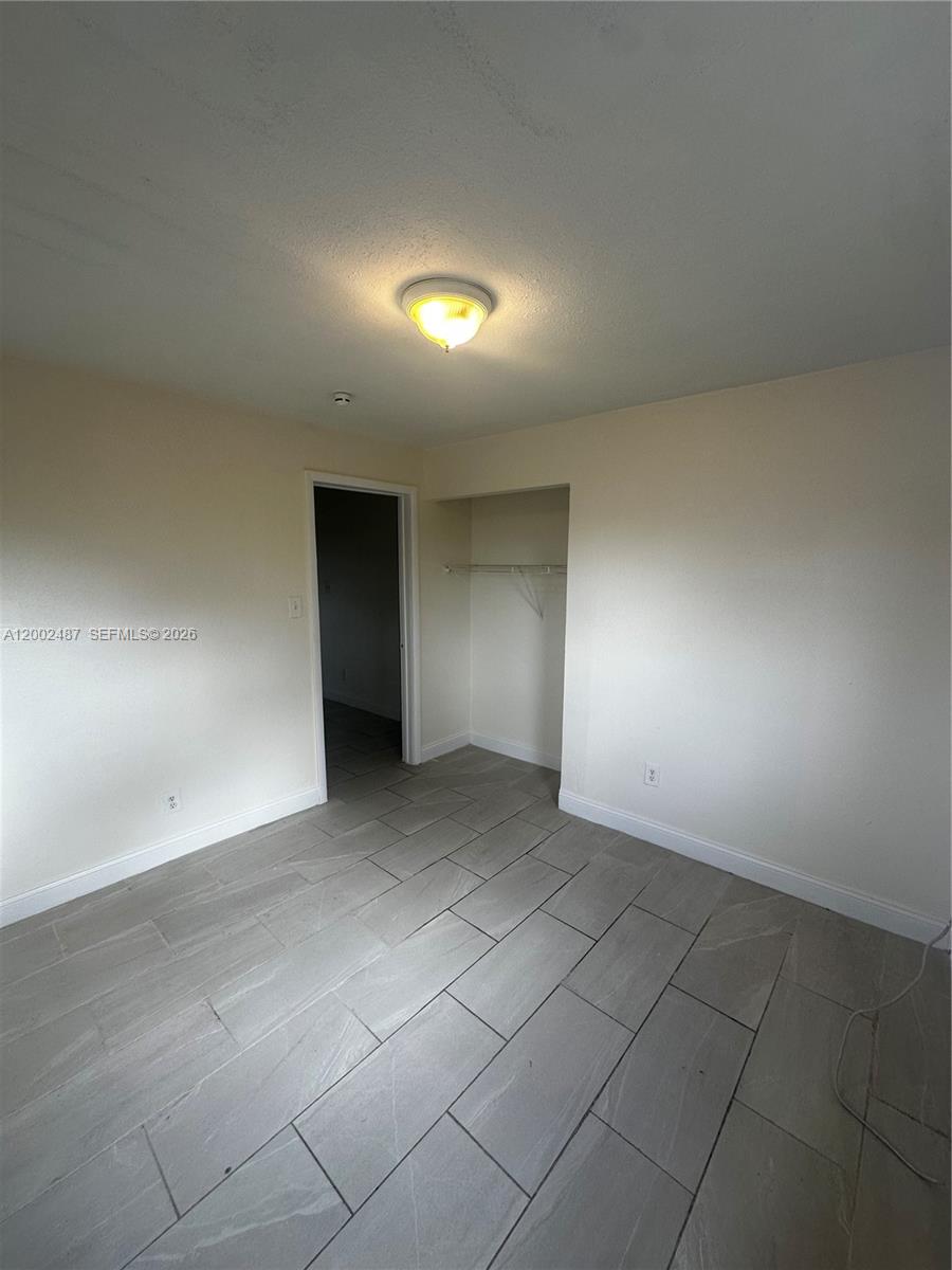11862 Southwest 212th Street, Unit 11862 Miami, FL 33177 - Photo 3 of 24 an empty room with a natural light
