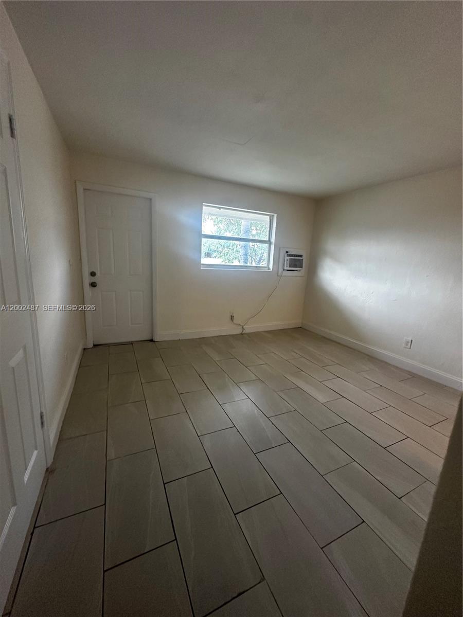 11862 Southwest 212th Street, Unit 11862 Miami, FL 33177 - Photo 5 of 24 an empty room with white walls and tiles