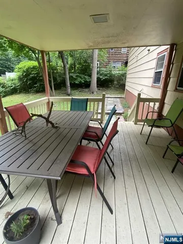 a view of a patio with wooden floor and furniture