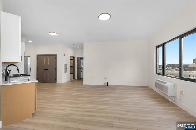 a view of a kitchen with a sink and a window