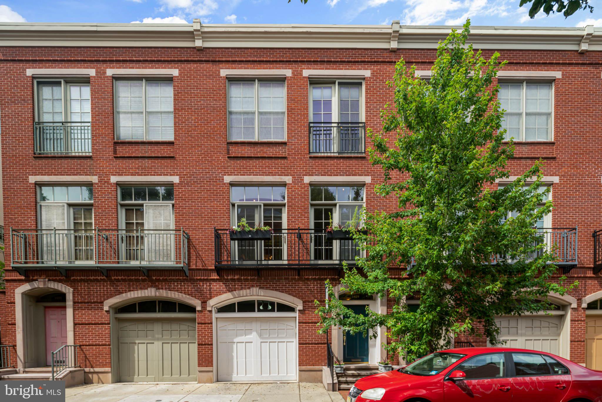 a front view of a house with car parked