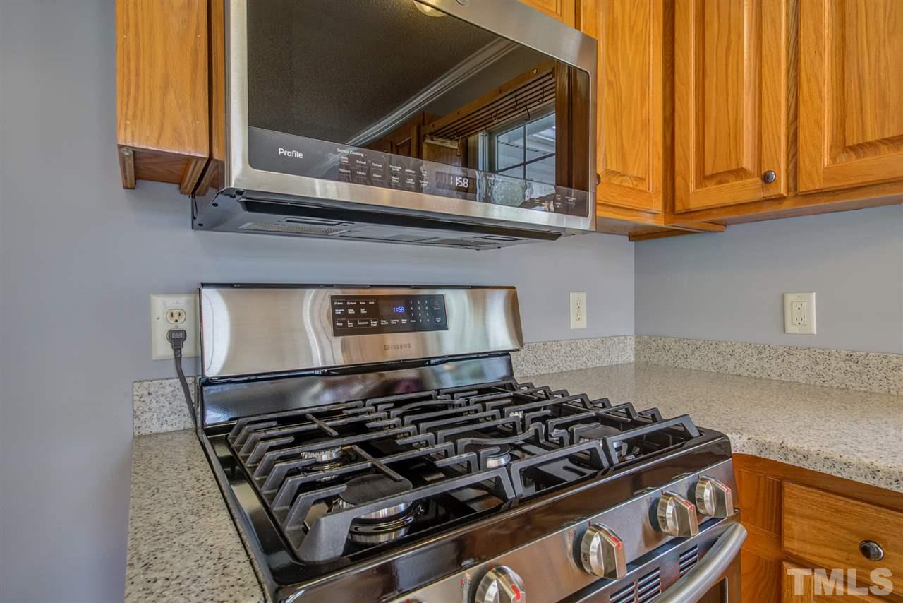 1020 Transom Court Raleigh, NC 27603 - Photo 13 of 30 a stove top oven sitting inside of a kitchen