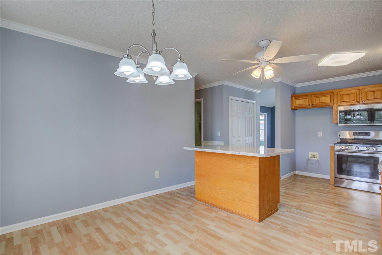 1020 Transom Court Raleigh, NC 27603 - Photo 16 of 30 a view of a room with wooden floor and chandelier
