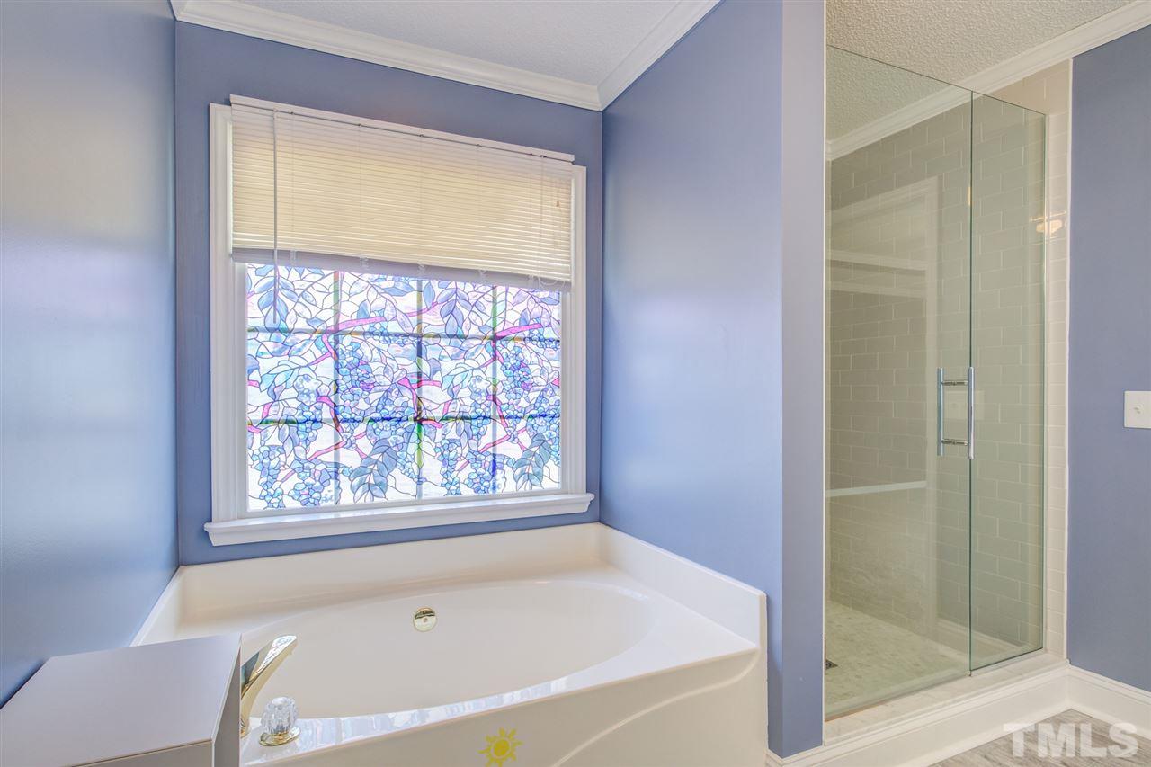 1020 Transom Court Raleigh, NC 27603 - Photo 23 of 30 a bath tub sitting next to a window