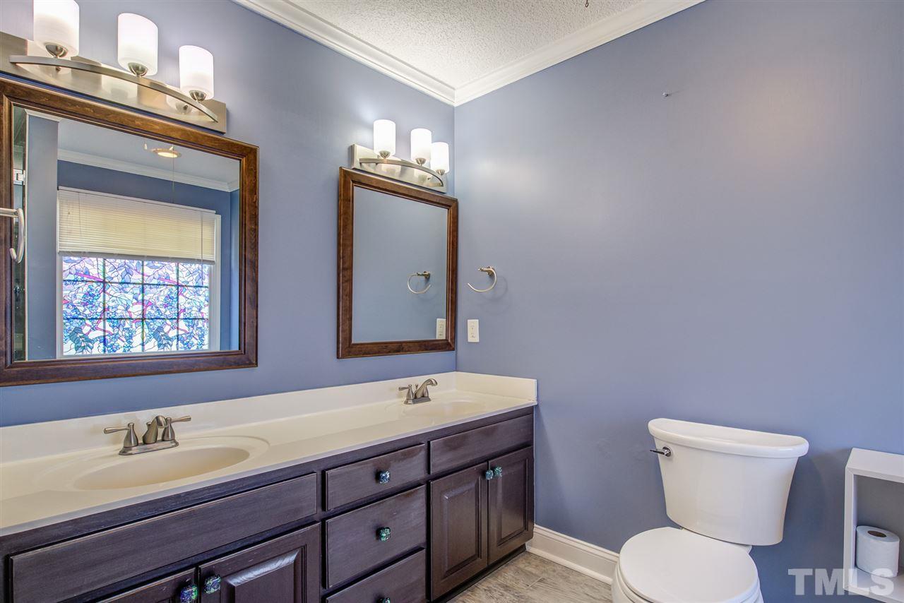 1020 Transom Court Raleigh, NC 27603 - Photo 24 of 30 a bathroom with a toilet sink and mirror