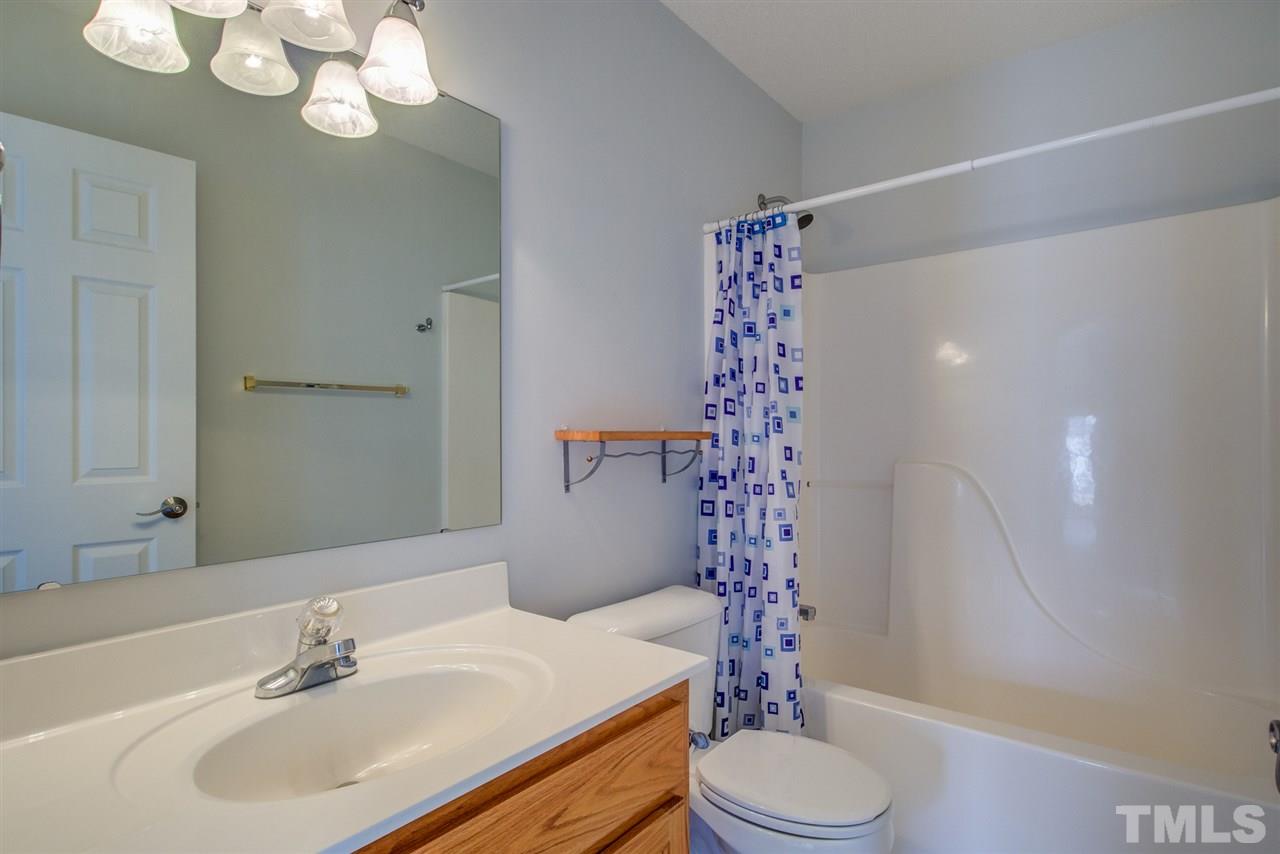 1020 Transom Court Raleigh, NC 27603 - Photo 27 of 30 a bathroom with a sink a toilet and a shower curtain