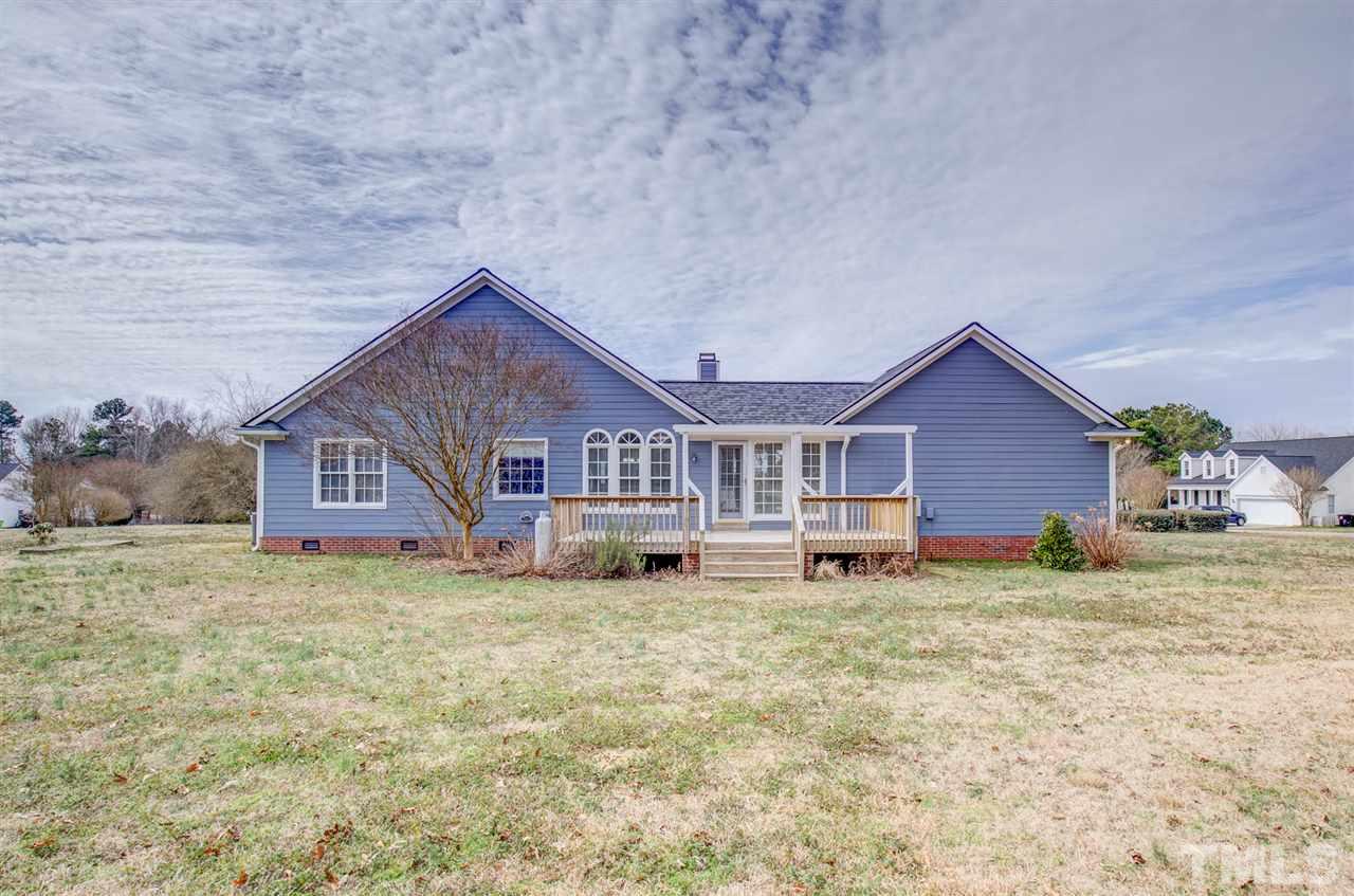 1020 Transom Court Raleigh, NC 27603 - Photo 29 of 30 a house that has a big yard with wooden fence and some plants