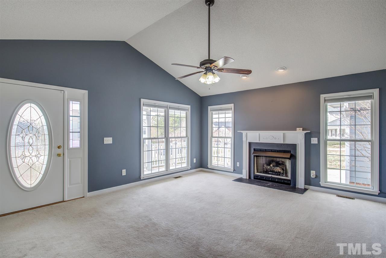 1020 Transom Court Raleigh, NC 27603 - Photo 7 of 30 a view of livingroom with furniture a fireplace and window