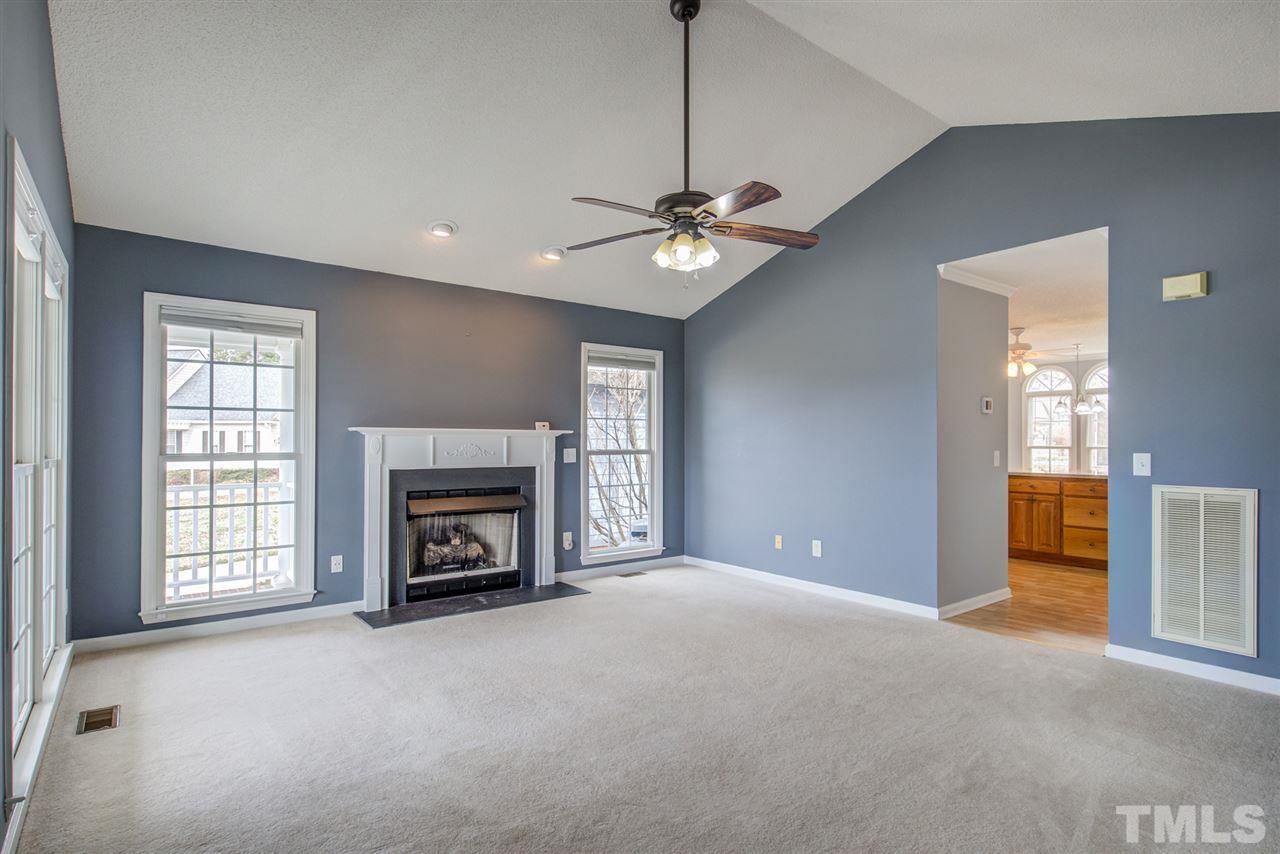 1020 Transom Court Raleigh, NC 27603 - Photo 8 of 30 a view of a livingroom with a fireplace chandelier fan and windows