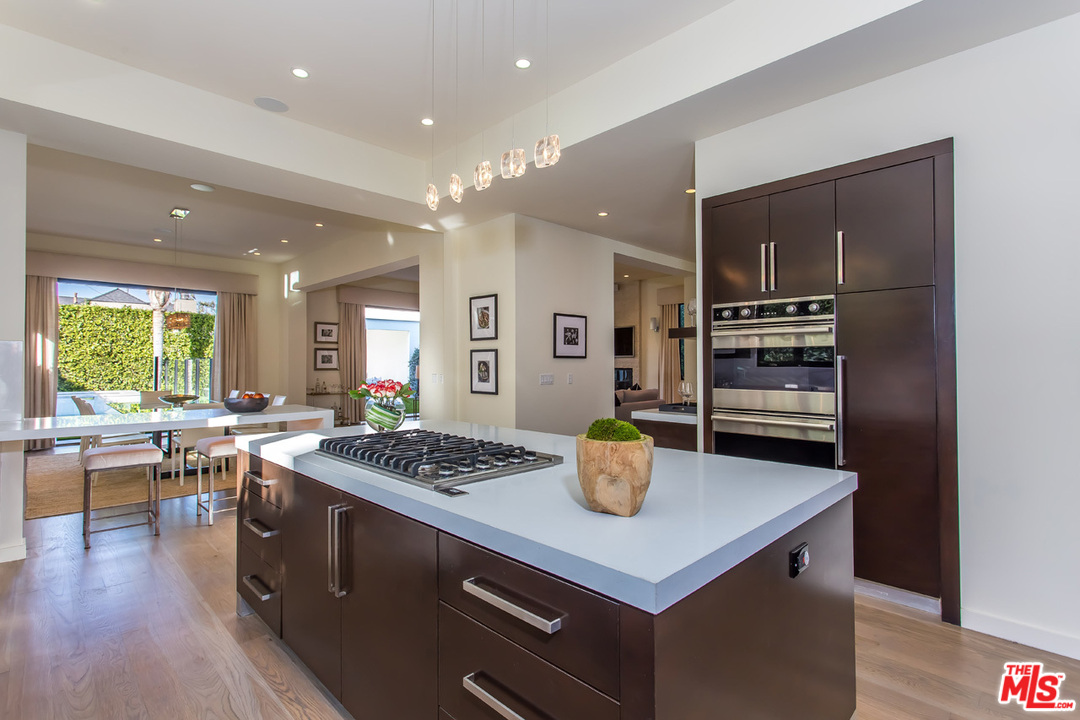 6533 Colgate Avenue Los Angeles, CA 90048 - Photo 13 of 19 a kitchen with a stove a refrigerator and wooden floor