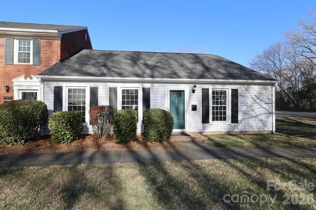 a view of a house with backyard and porch
