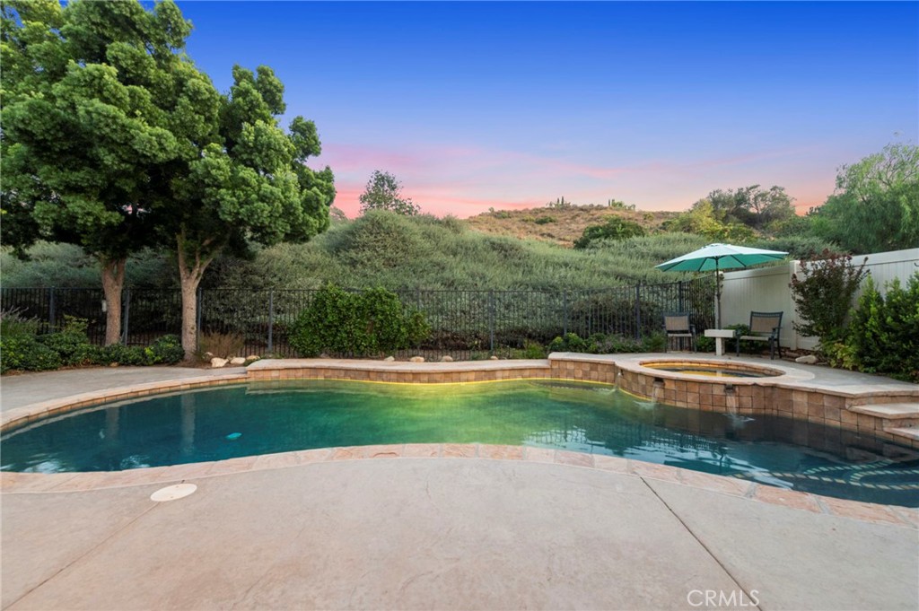a view of backyard with swimming pool and outdoor seating