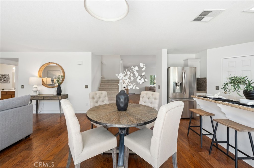 33751 Abbey Road Temecula, CA 92592 - Photo 14 of 41 a view of a dining room with furniture and wooden floor