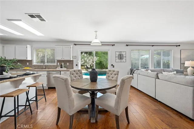a view of a dining room with furniture and wooden floor