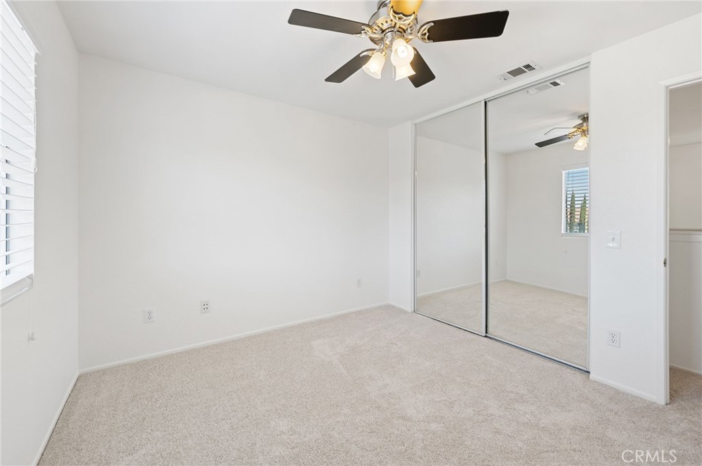 33751 Abbey Road Temecula, CA 92592 - Photo 23 of 41 an empty room with closet and a chandelier fan