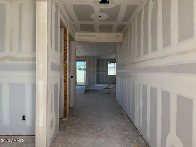 a view of a hallway with a livingroom and a livingroom with furniture