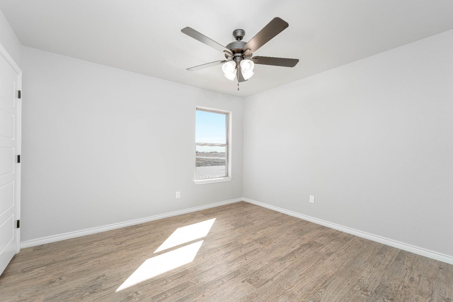 1407 17th Street, Unit AB Shallowater, TX 79363 - Photo 12 of 33 an empty room with wooden floor closet and ceiling fan