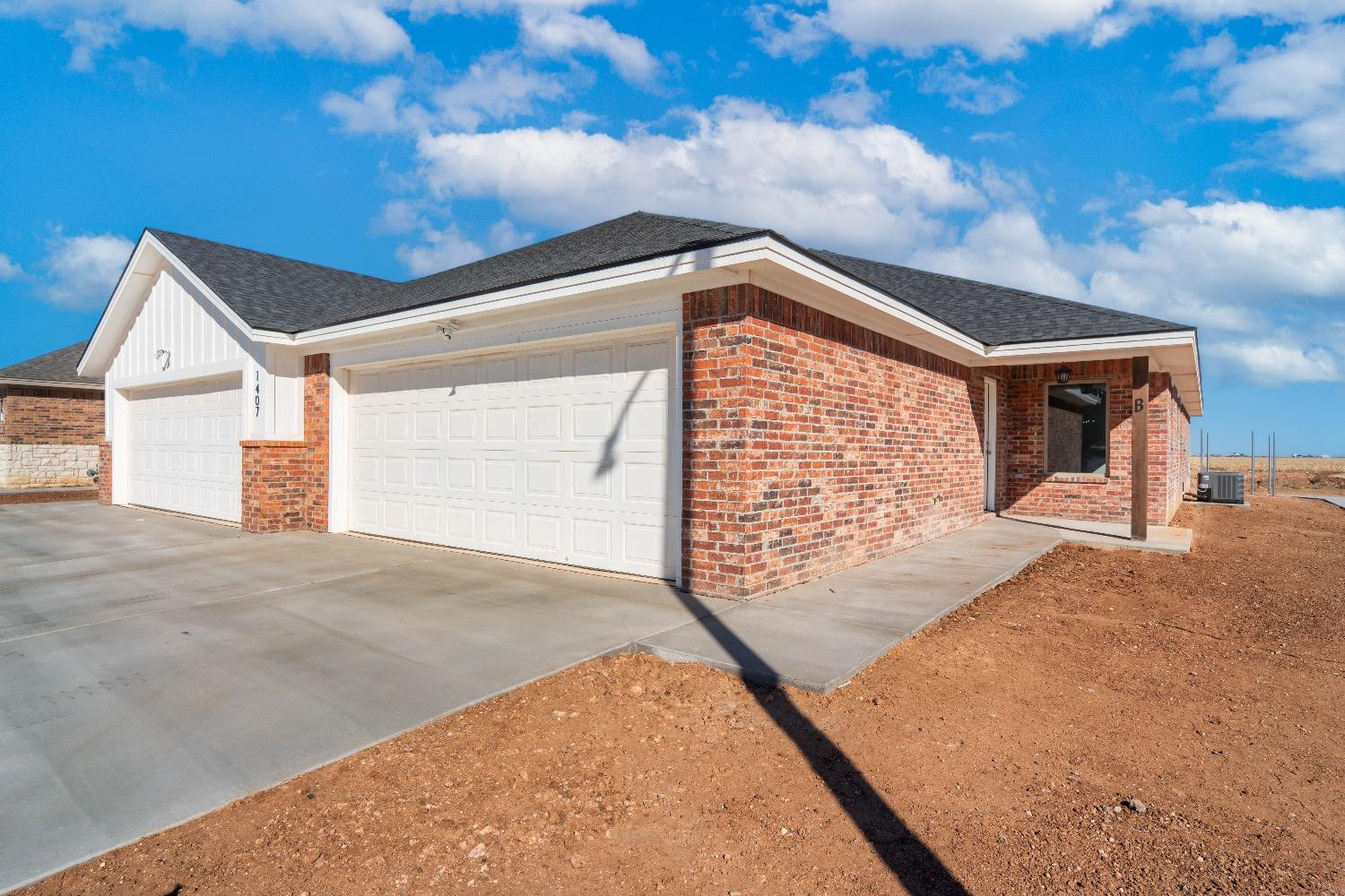 1407 17th Street, Unit AB Shallowater, TX 79363 - Photo 2 of 33 a front view of a house with a garage