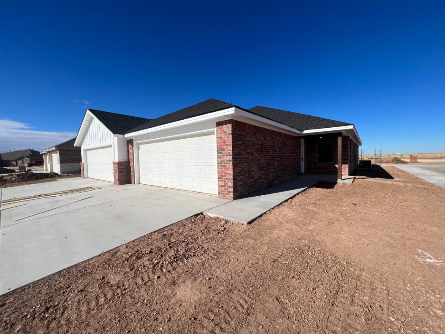 1407 17th Street, Unit AB Shallowater, TX 79363 - Photo 31 of 33 a front view of a house with a yard