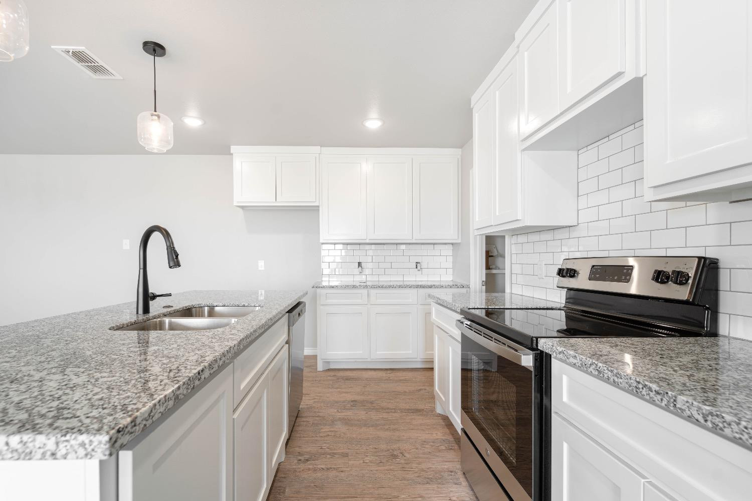 1407 17th Street, Unit AB Shallowater, TX 79363 - Photo 5 of 33 a kitchen with sink stove and cabinets