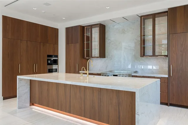 a kitchen with a sink and large cabinets