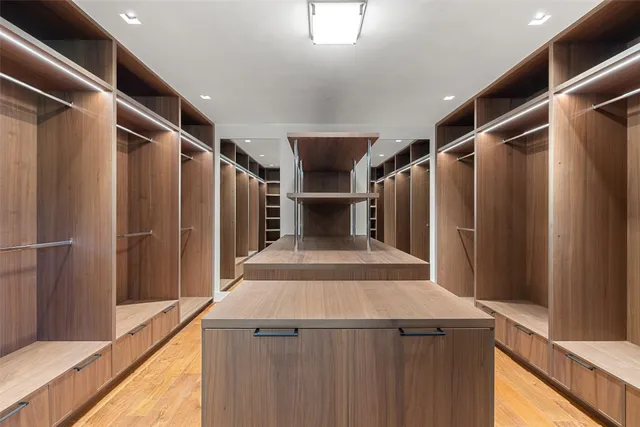 a spacious bathroom with a bathtub sink and mirror