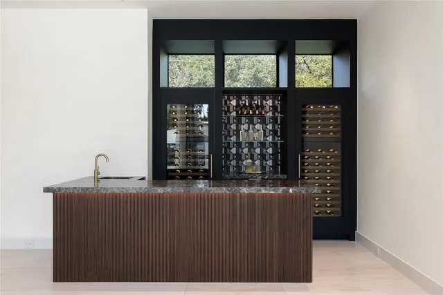 a living room with furniture and floor to ceiling windows