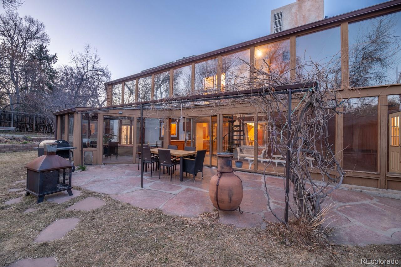 14080 Crabapple Road Golden, CO 80401 - Photo 40 of 50 a view of a patio with table and chairs potted plants and large tree