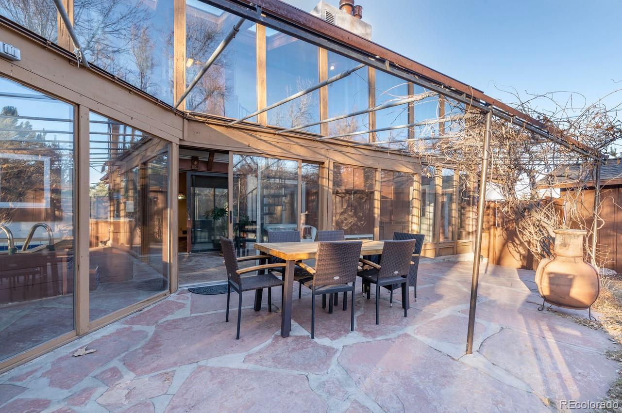 14080 Crabapple Road Golden, CO 80401 - Photo 41 of 50 a view of a patio with table and chairs and floor to ceiling window