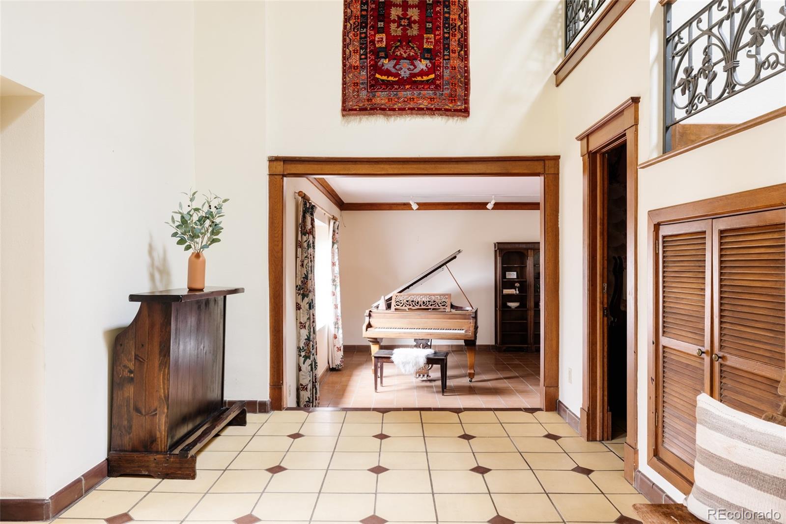 14080 Crabapple Road Golden, CO 80401 - Photo 5 of 50 a view of a hallway with wooden floor and a living room