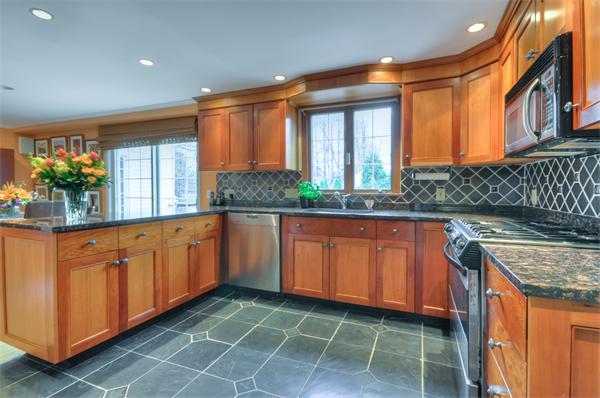 3 Wildon Road Wellesley, MA 02482 - Photo 7 of 27 a kitchen with granite countertop a stove a sink and a wooden cabinets