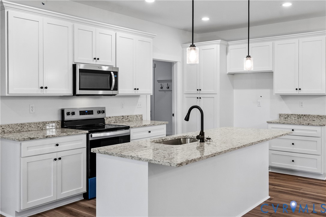 1841 Cartersville Road Goochland, VA 23063 - Photo 11 of 34 a kitchen with granite countertop white cabinets white stainless steel appliances and a sink