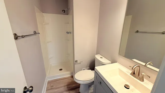 a white toilet sitting next to a bathroom sink