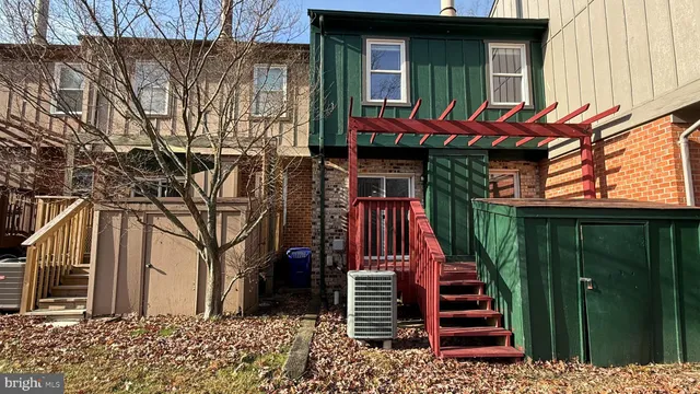a view of a house with a door and wooden walls