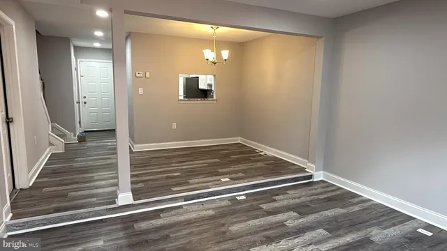 a view of a livingroom with wooden floor and staircase