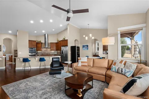 a living room with furniture kitchen and a table