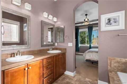 a spacious bathroom with a sink double vanity and a mirror