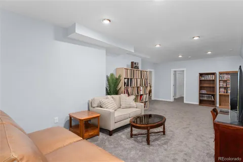 a living room with furniture a air conditioner vent and a window