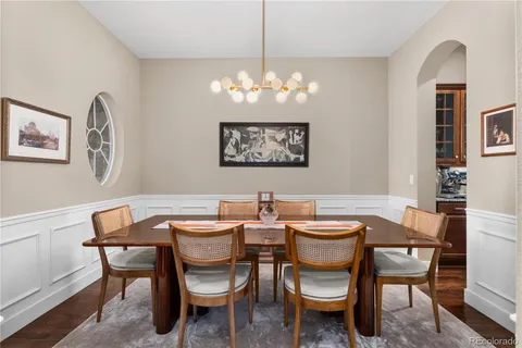 a view of a dining room with furniture and chandelier