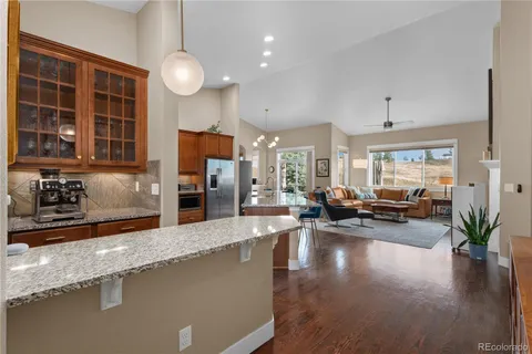 a view of a living room kitchen and a large window
