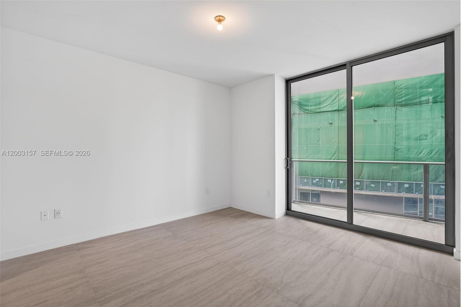 77 Southeast 5th Street, Unit 2705 Miami, FL 33131 - Photo 11 of 45 a view of an empty room with glass door